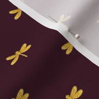 gold dragonfly on bordeaux 