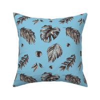 Monochrome tropical leaves and flowers on blue