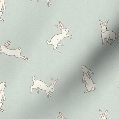 Leaping white bunny rabbits on dusty blue with linen texture