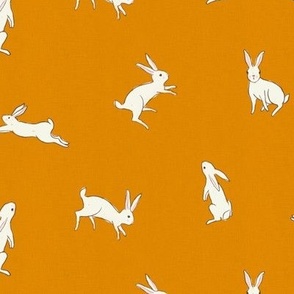 Leaping white bunny rabbits on mustard with linen texture
