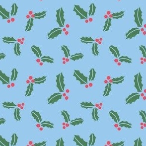 Christmas holly leaves and berries on sky blue