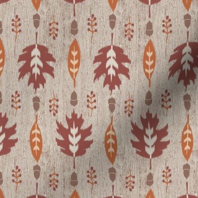 Ikat autumn leaves red and orange on wood texture - small scale