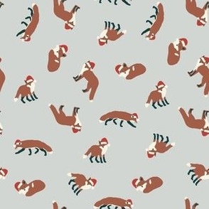 Red Foxes in Santa Hats Tossed in Earth Tones on a Light Blue Background