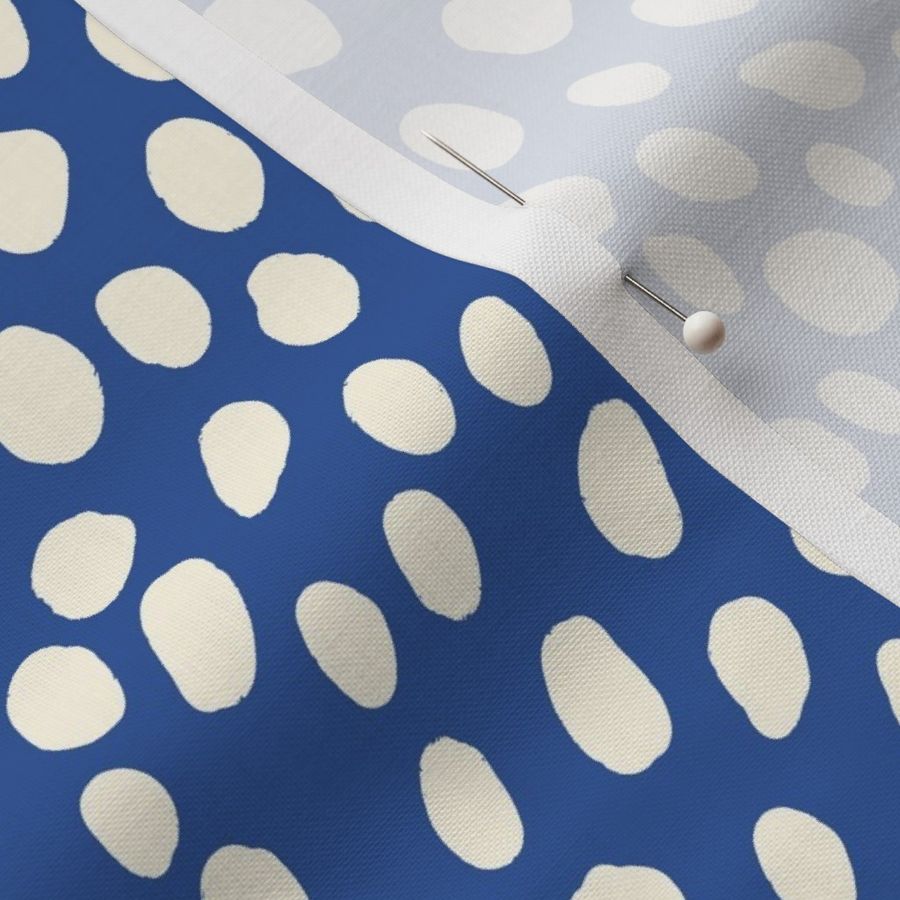 Dalmatian Spots: cream dots and spots on dark blue background.