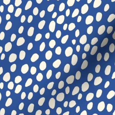 Dalmatian Spots: cream dots and spots on dark blue background.