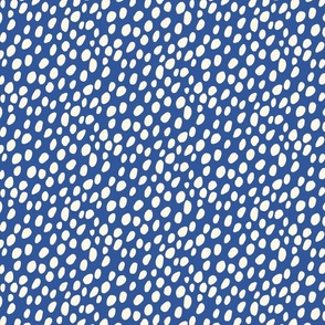 Dalmatian Spots: cream dots and spots on dark blue background.