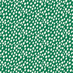 Dalmatian Spots: cream dots and spots on green background.