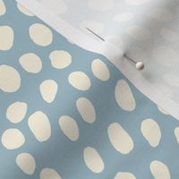 Dalmatian Spots: cream dots and spots on light blue background.