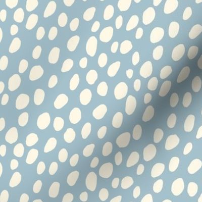 Dalmatian Spots: cream dots and spots on light blue background.