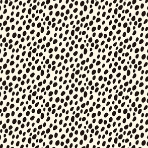 Dalmatian Spots: black dots and spots on cream background.