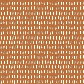 Organic Dash Design: cream dash marks on brown background.