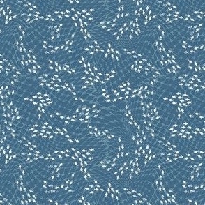 (S) white fish swarm behind blue fishing net on denim blue