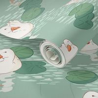 White ducks swimming in lake with lily pads (medium size version)