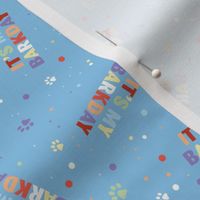 Colorful rainbow barkday design with confetti paws and happy birthday text tossed for dogs on blue boys