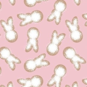 Little minimalist Easter bunnies - baked spring cookies powdered sugar on cookie dough on pink 