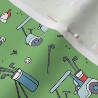 Day on the golf course - Golf clubs and golf ball standbag cart and cup with flag on the green  red blue on green