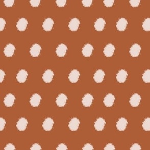 Pink fuzzy polka dots on terra cotta red