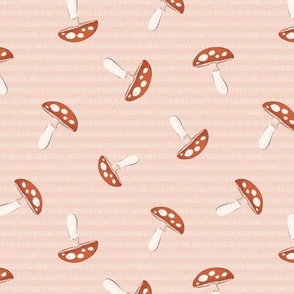 Red scattered mushrooms on pink background, medium scale