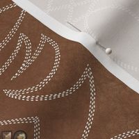 Cowboy stitches and tacks on leather