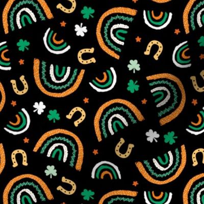 St Patrick's Day rainbows and lucky horse shoe stars and shamrock leaves orange green on black 