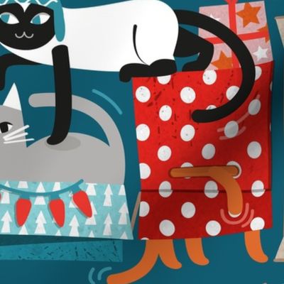 Large jumbo scale // Purfect Christmas gifts // teal background cute cats in cardboard red and teal wrapped boxes and holiday ornaments ribbons balls and lights 