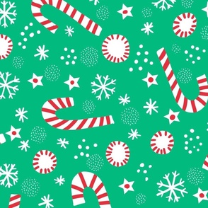 Christmas candy canes on festive green wallpaper scale