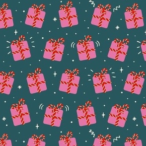 Cute pink christmas presents on dark green, gift boxes with striped ribbon