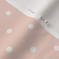 White polka dots on pale pastel blush