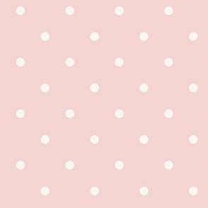White polka dots on pale pastel pink