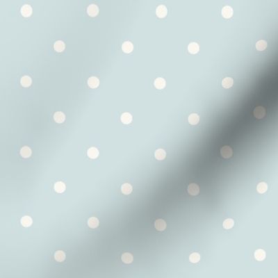 White polka dots on pale pastel blue green