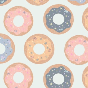 Large Majestic Donuts in muted pastel blue, pink and yellow on a mint green background