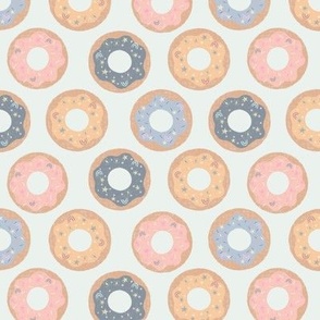 Small Majestic Donuts in muted pastel blue, pink and yellow on a mint green background