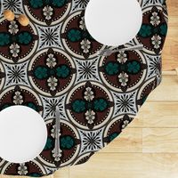 Arabesque half drop circles with leaves and radiating mandalas in night swim teal and molasses with eggshell, panna cotta and morel with a crackled porcelain texture 12” repeat four directional