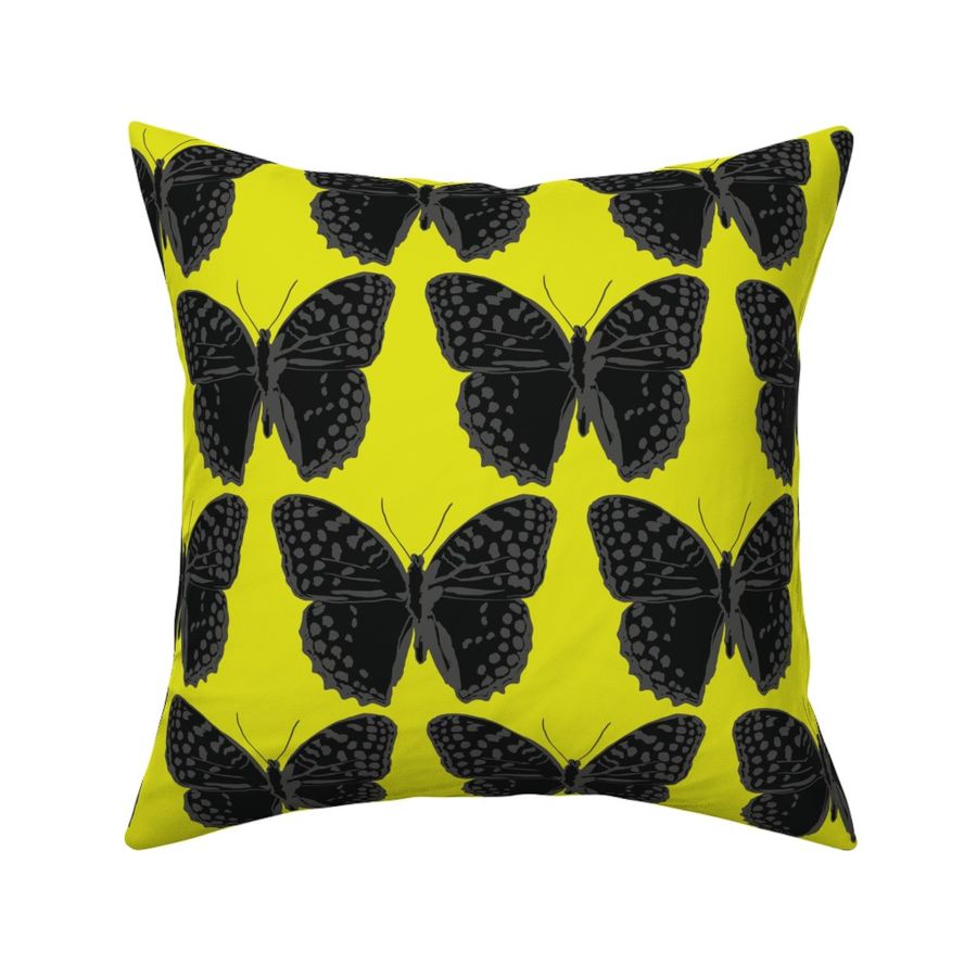 medium spotted butterflies gray and black on lime