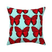 medium spotted butterflies red and black on light turquoise