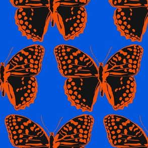 large spotted butterflies poppy red and black on classic blue