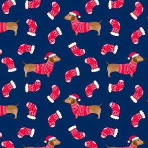 Dachshund wearing jumper and santa hat on blue background, cute sausage dogs with christmas stockings