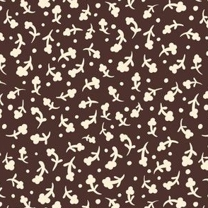 Small cream white flower silhouette on chocolate brown