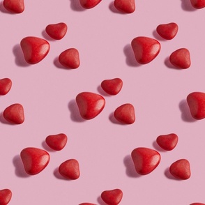 Candy hearts on pink background