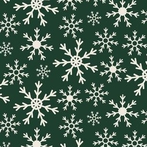 cream snowflakes on dark green background
