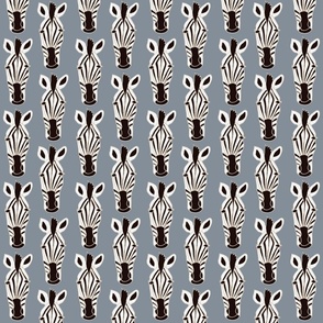 Hand drawn zebra trophy faces in black and white on denim blue background