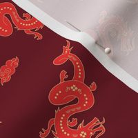 Chinese new year theme - year of the dragon with puffy clouds tossed red yellow on burgundy