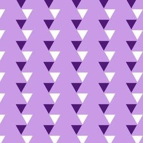 Off kilter purple and white repeating triangles  arranged in vertical stripes