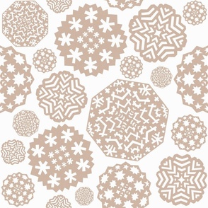 Paper cut out delicate beige snowflakes on an white background