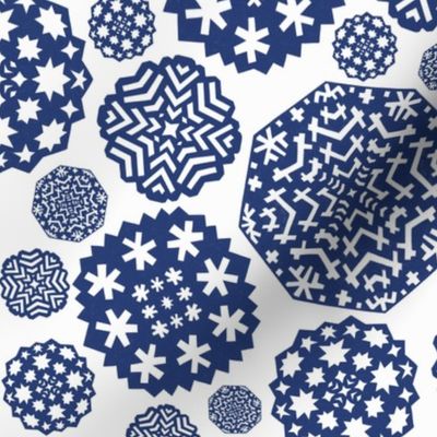 Paper cut out delicate dark blue snowflakes on an white background
