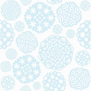 Paper cut out delicate light blue snowflakes on an white background
