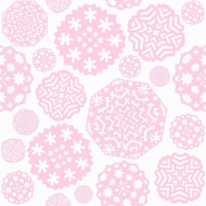 Paper cut out delicate pink snowflakes on an white background