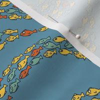 School of colourful fish moving in waves on a light blue background - small