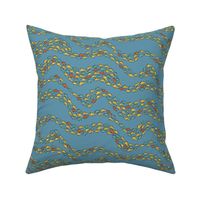 School of colourful fish moving in waves on a light blue background - small