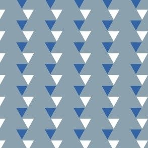 Off kilter blue and white triangles on blue-gray background